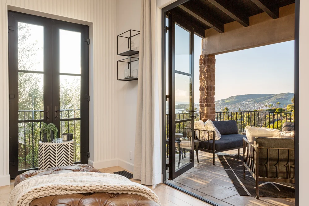 Bedroom with French doors opening to balcony lounge