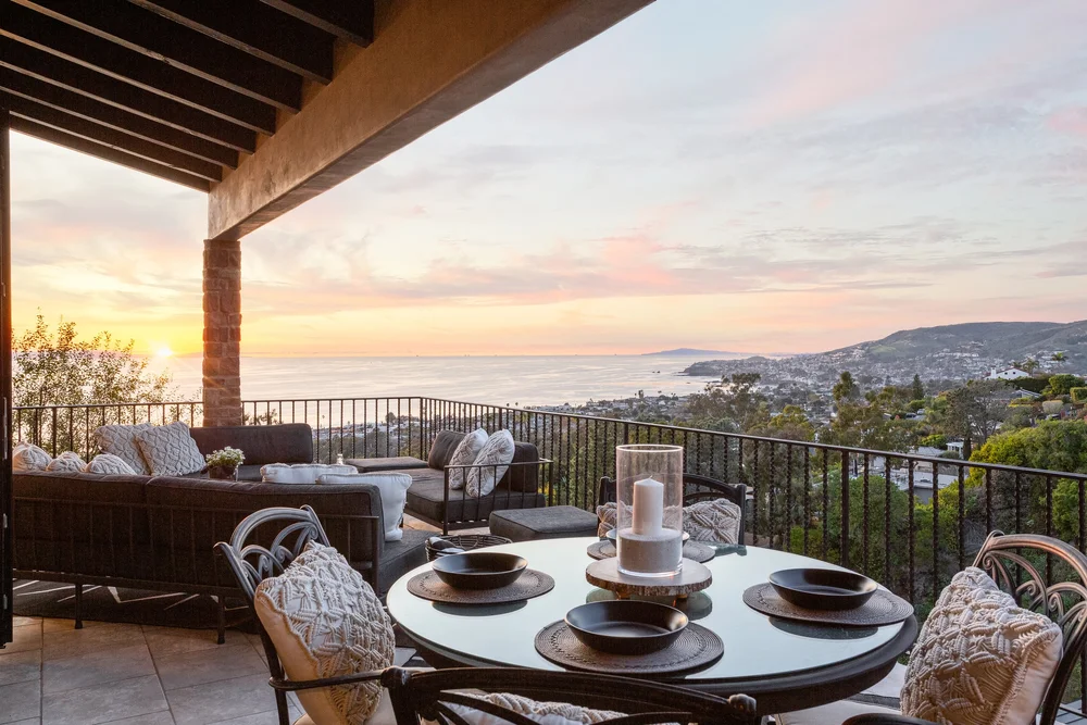 Covered terrace dining at sunset with ocean view