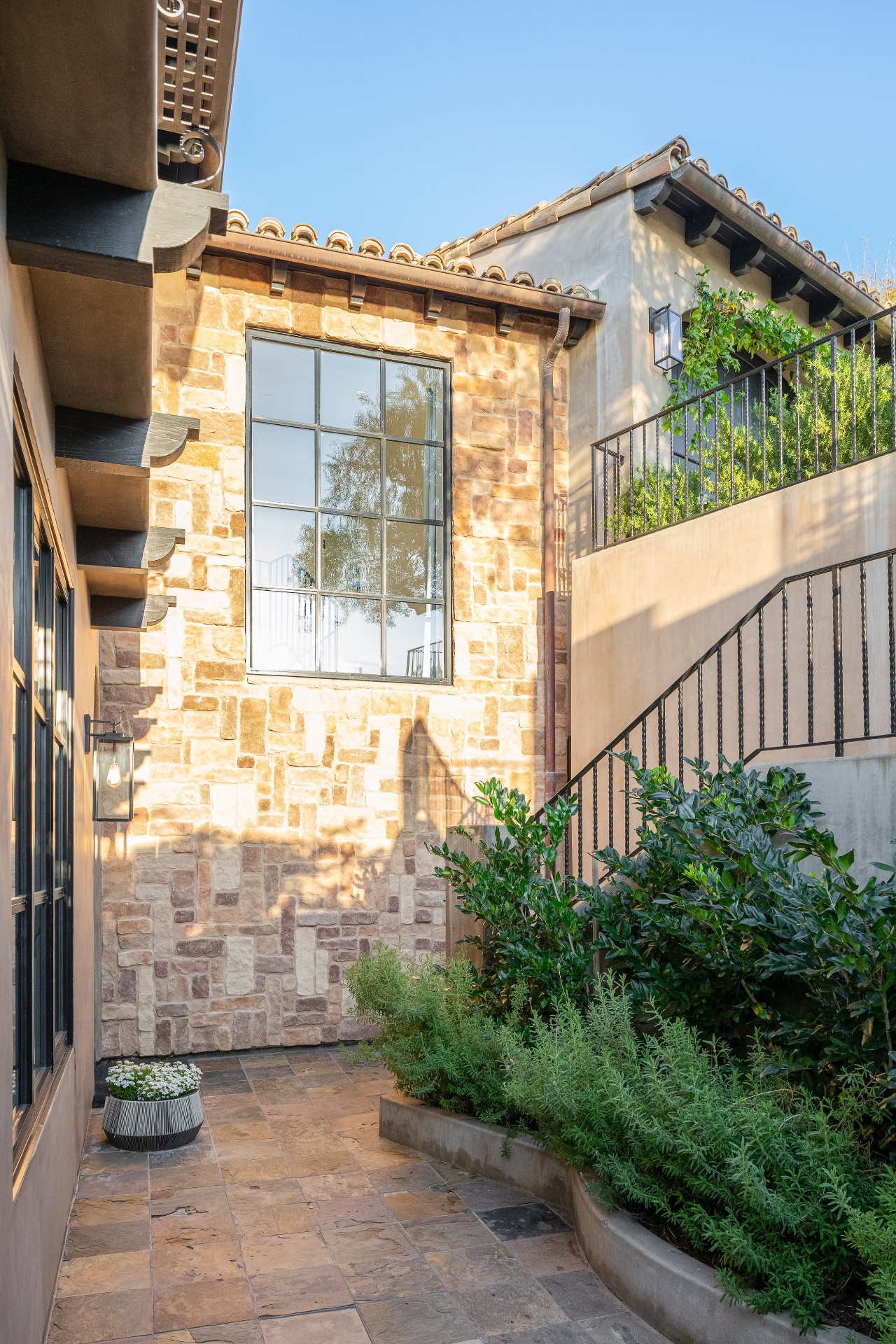 Stone courtyard with iron stair and herb garden